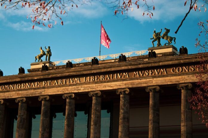ddr museum berlin - Elegant facade of Altes Museum in Berlin with sunlight illuminating classical ar